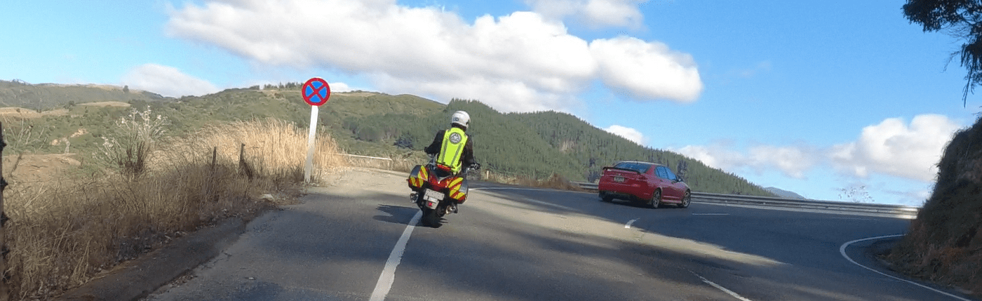 A motorcycle rider taking a tight curve to the right on the open road